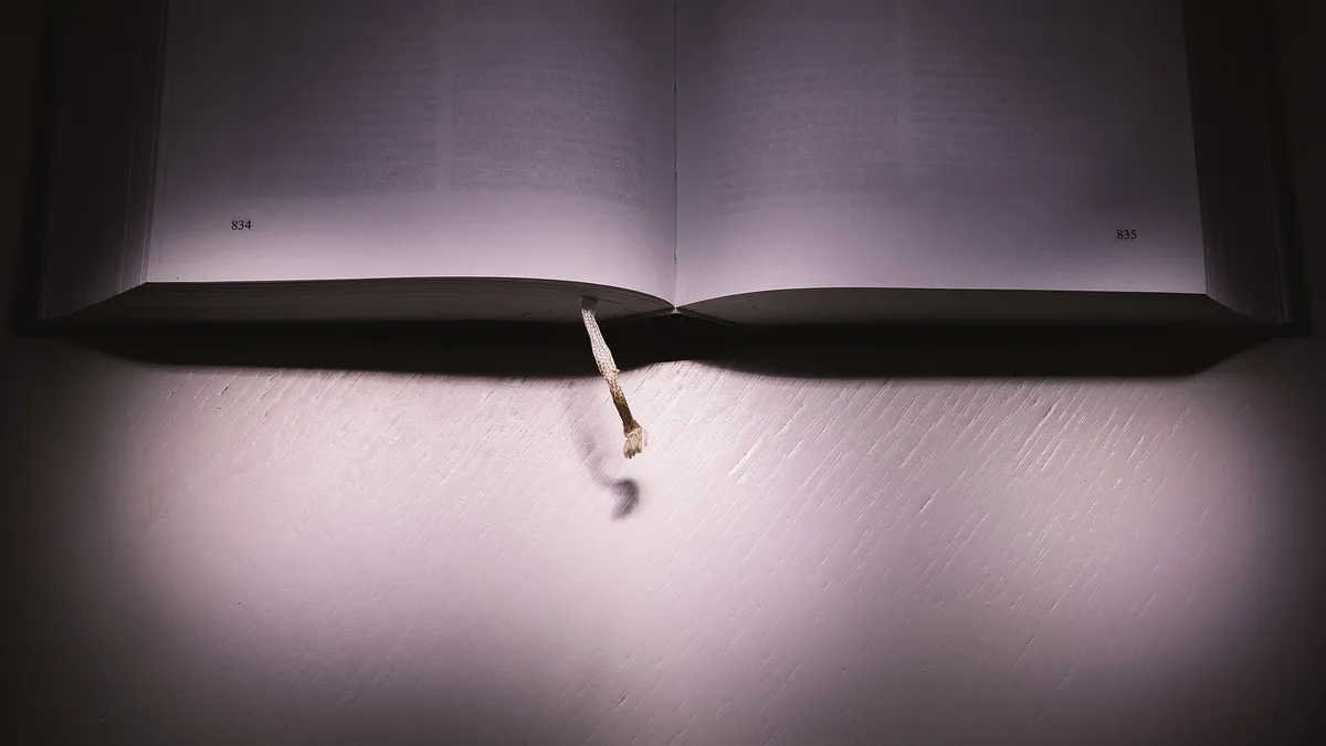 An open grammar textbook on a wooden desk with notes