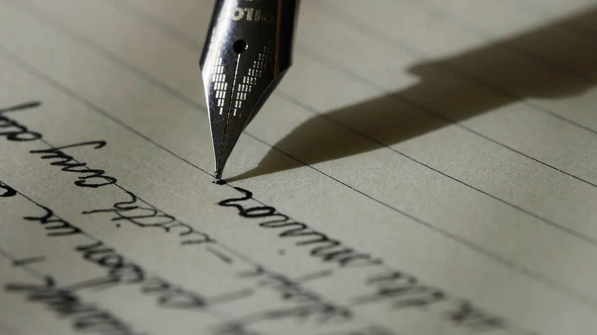 A notebook with handwritten French text on a cafe table